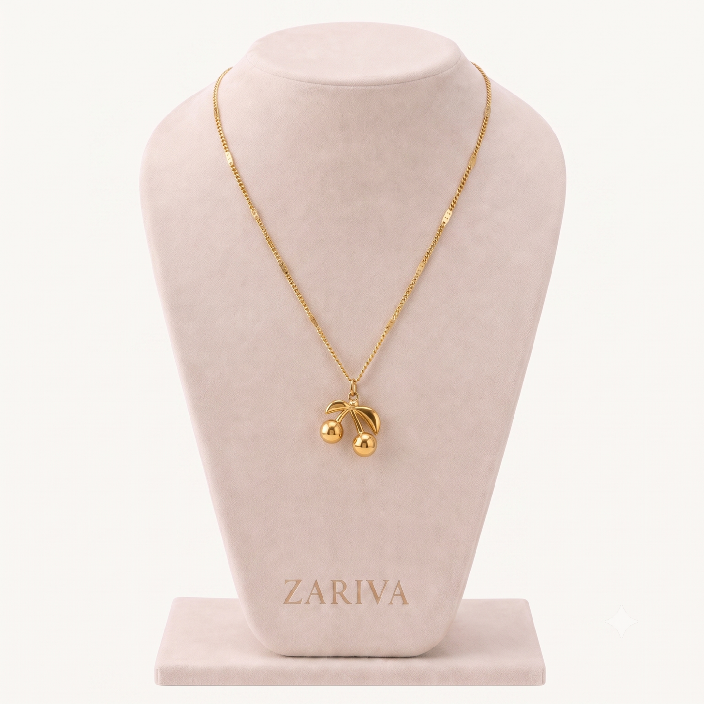 Cherry pendant necklace featuring a polished gold-tone double-cherry charm with curved leaf details on a delicate chain.
