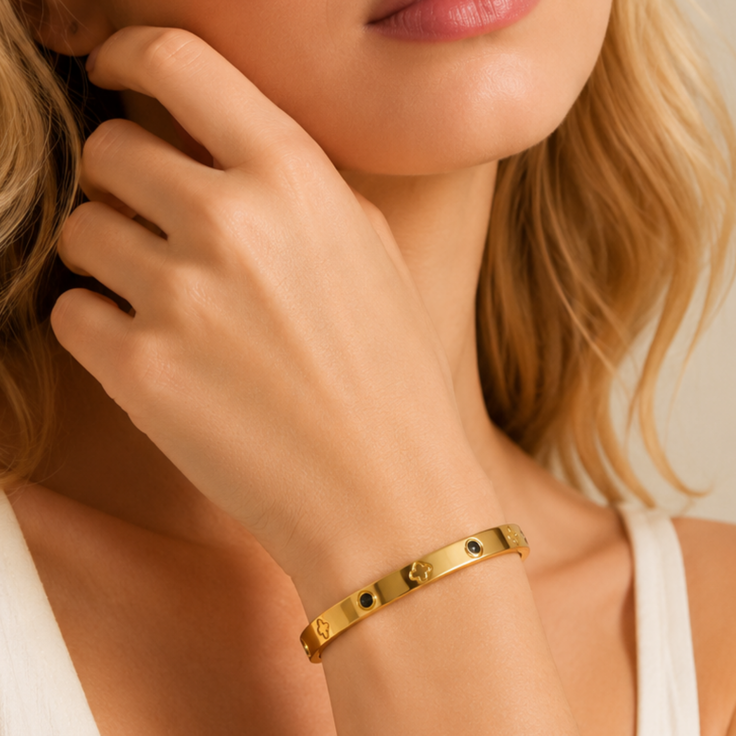 Zariva Noir Clover Luxe Bangle in 18K Gold PVD plated SS316L stainless steel featuring black onyx-inspired accents and signature clover motifs. Anti-tarnish, water-resistant, hypoallergenic everyday luxury bangle for women.