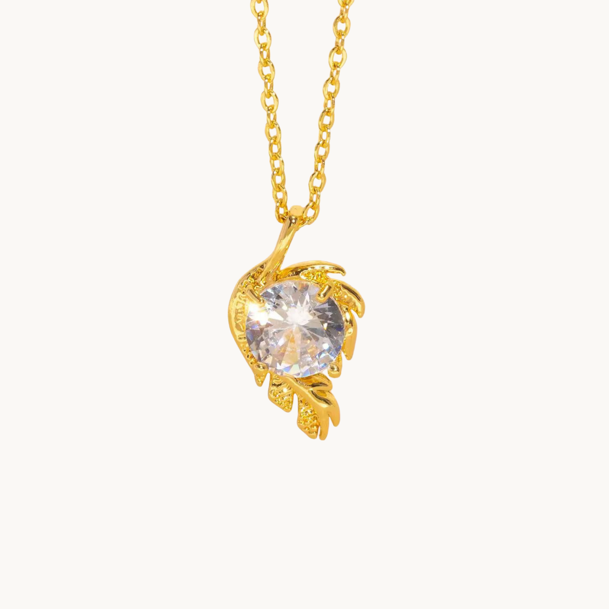 Gold solitaire necklace featuring a round clear stone in an elegant floral pendant, displayed on a clean white background by ZARIVA.