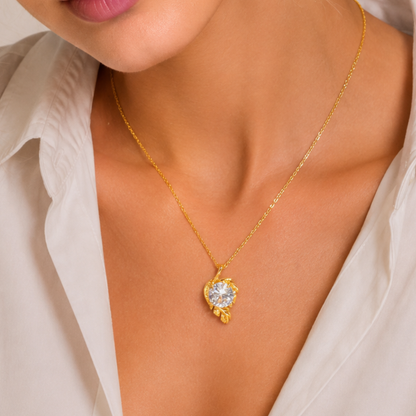 Gold solitaire necklace worn on the neckline, showcasing its round clear stone and graceful floral-inspired pendant by ZARIVA.