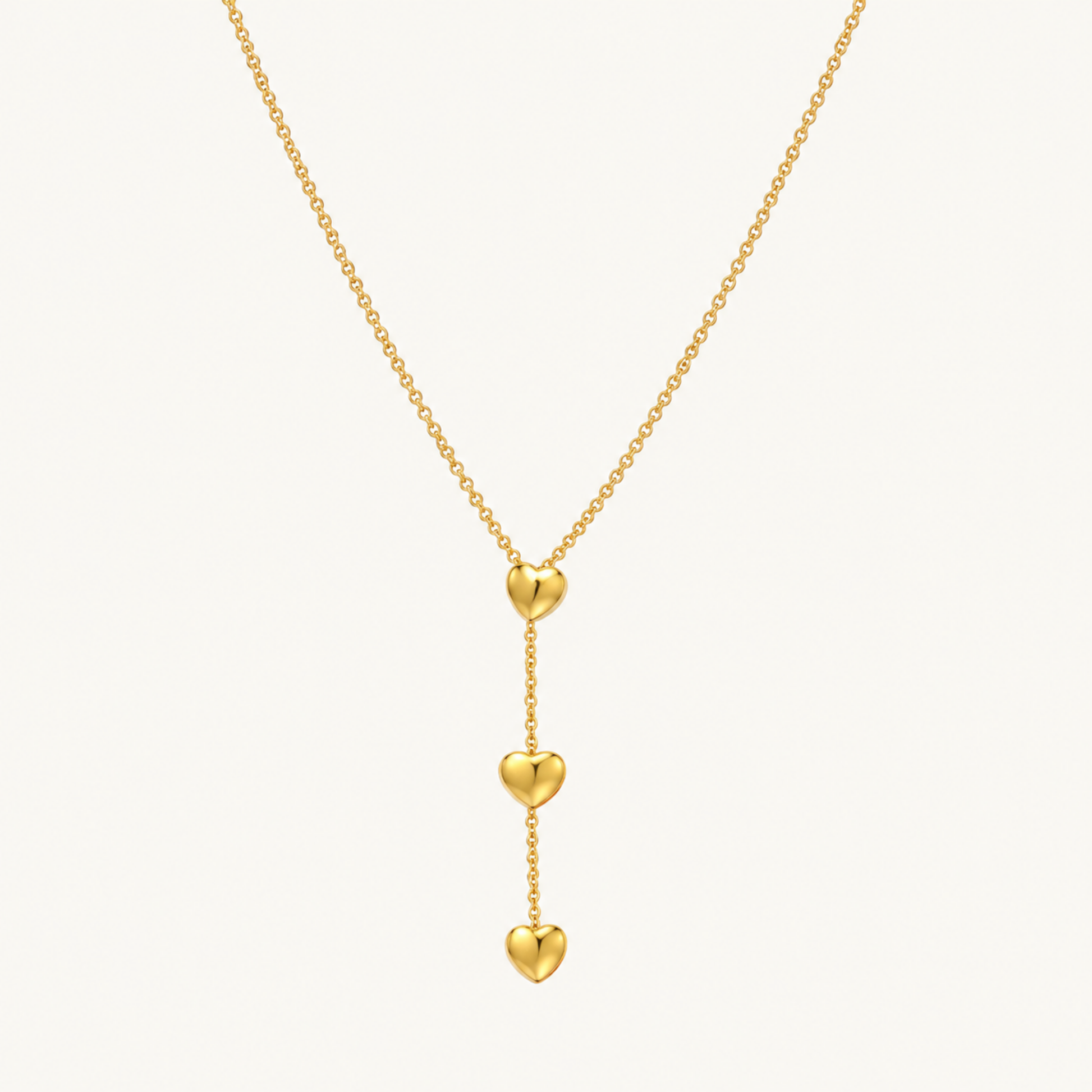 Amora Double Heart Lariat Necklace in gold with two cascading heart pendants and a delicate lariat chain by ZARIVA.