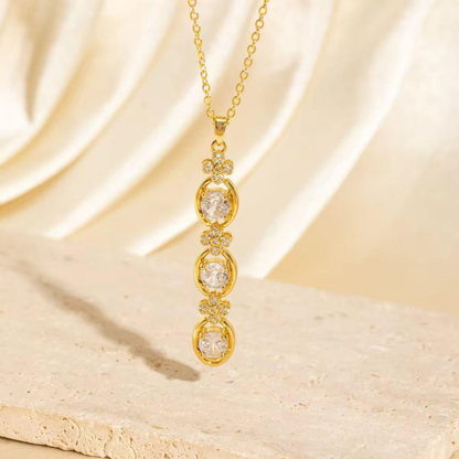 Aurelia Cascade Necklace featuring three sparkling round stones in a gold-tone cascading pendant with floral accents by ZARIVA