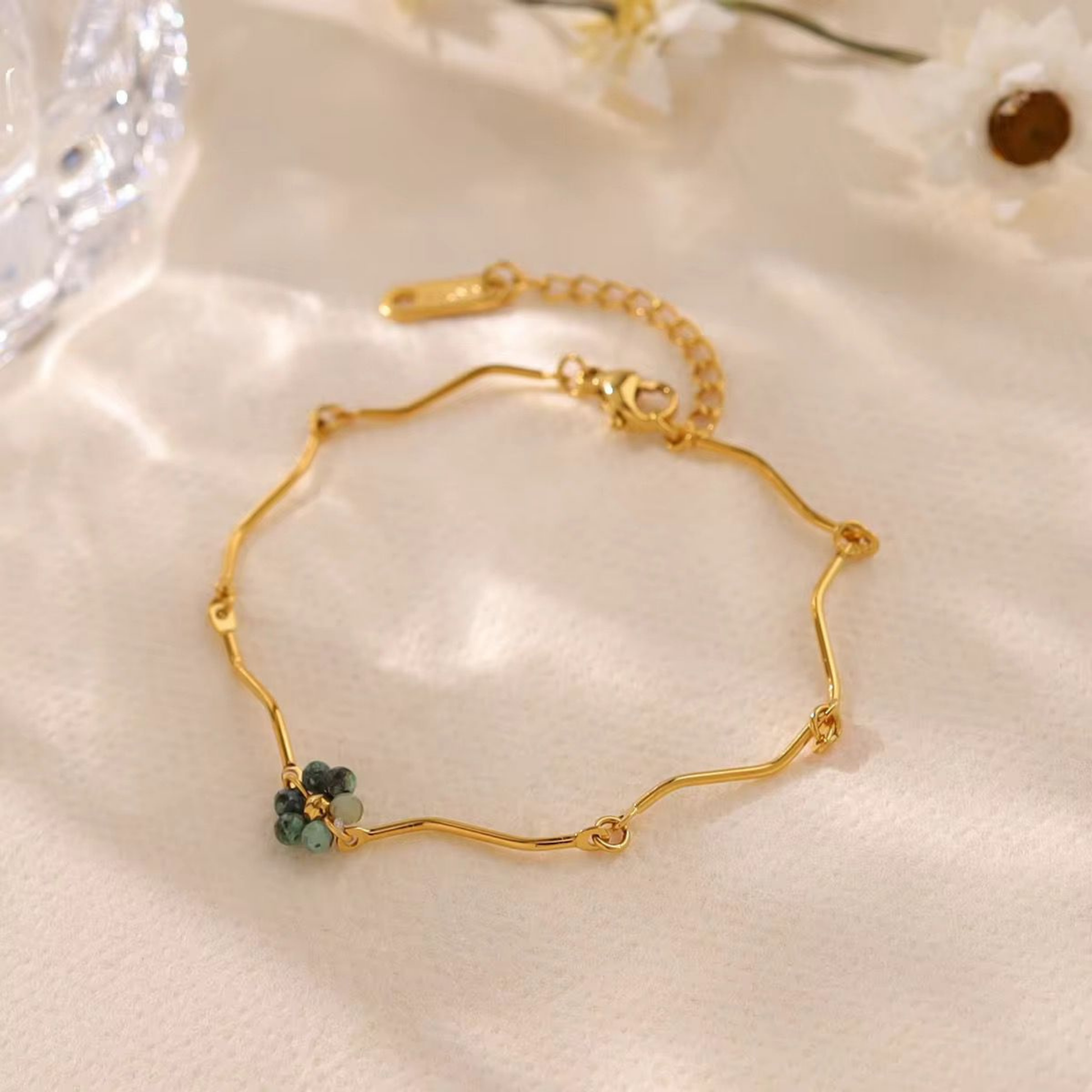 Beaded bracelet in gold with green beads styled on a woman's wrist for an elegant everyday jewellery look by ZARIVA.