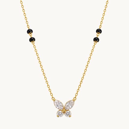Butterfly mangalsutra featuring a sparkling four-wing pendant, black beads and a gold-tone chain by ZARIVA