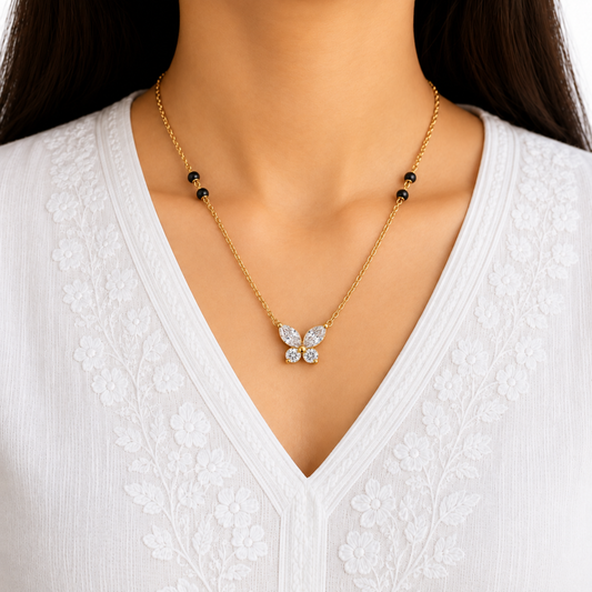 Butterfly mangalsutra styled on a woman, featuring clear crystal wings, black beads and a delicate gold-tone chain