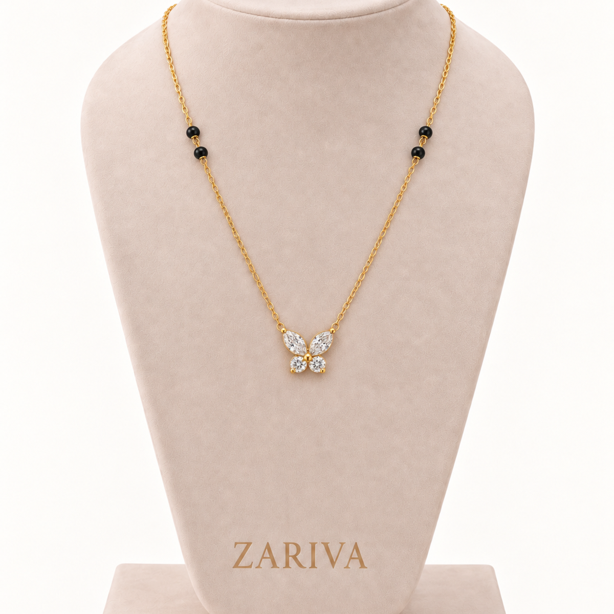 Butterfly mangalsutra displayed on a jewellery bust with clear crystal wings, black beads and a polished gold-tone chain