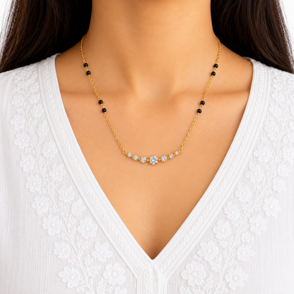 ZARIVA Celestia necklace featuring black beads and graduated clear crystals, styled with a white V-neck outfit for everyday elegance.