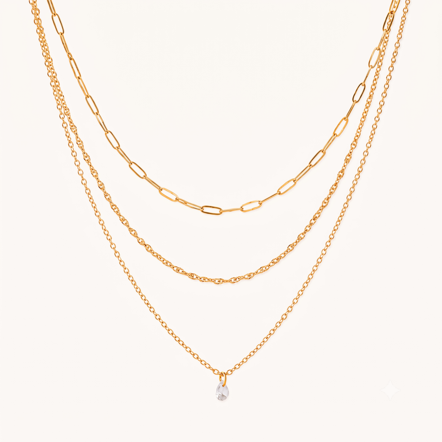 Crystal drop necklace with three layered gold chains and a clear teardrop charm, featuring the Aurelia design by ZARIVA.