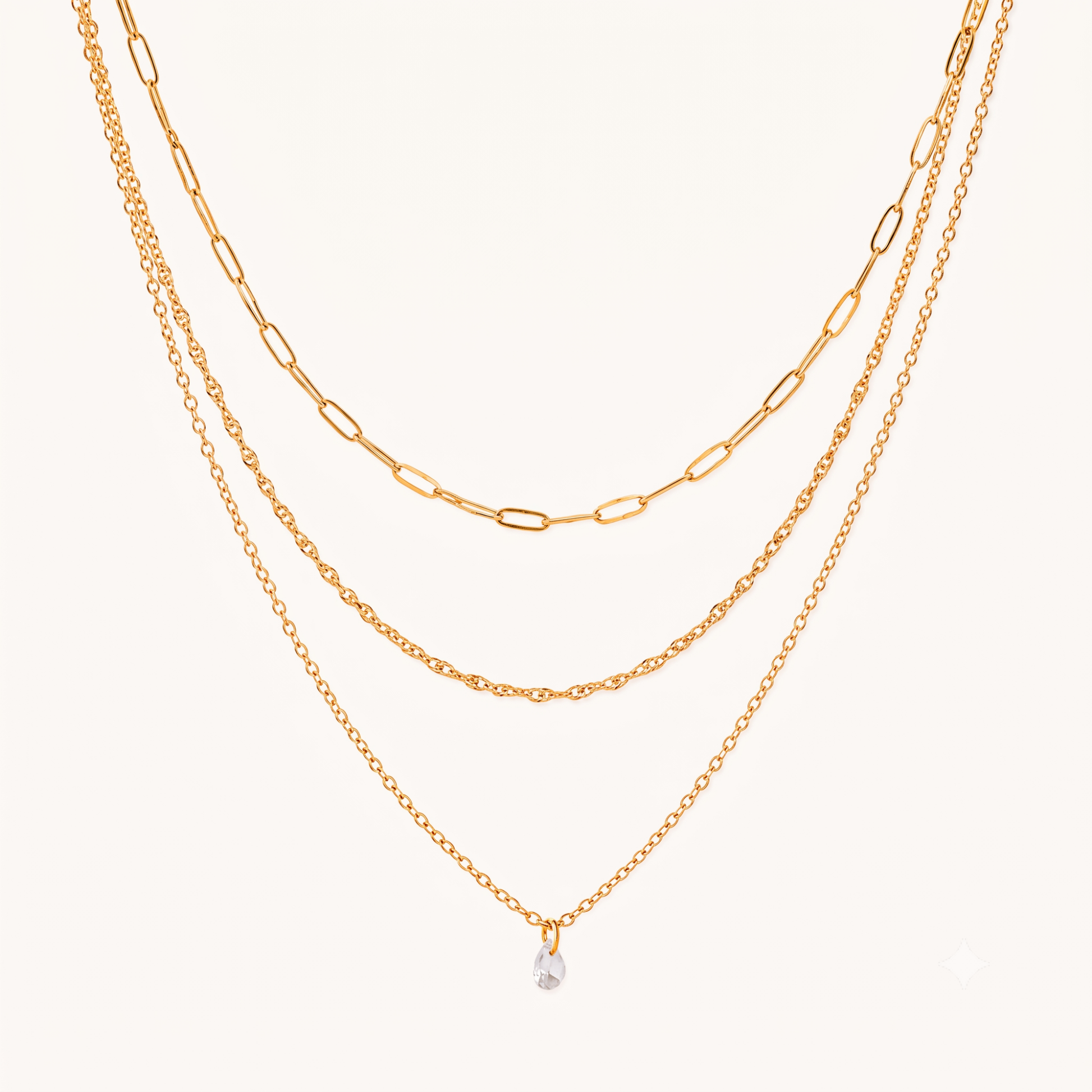 Crystal drop necklace with three layered gold chains and a clear teardrop charm, featuring the Aurelia design by ZARIVA.