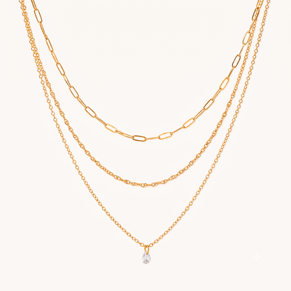 Crystal drop necklace with three layered gold chains and a clear teardrop charm, featuring the Aurelia design by ZARIVA.
