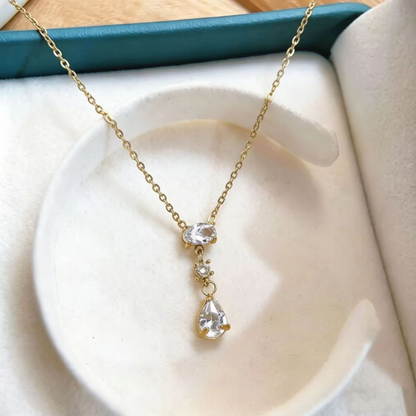 Crystal pendant necklace with layered oval, round and pear-shaped stones on a delicate gold-tone chain by ZARIVA.