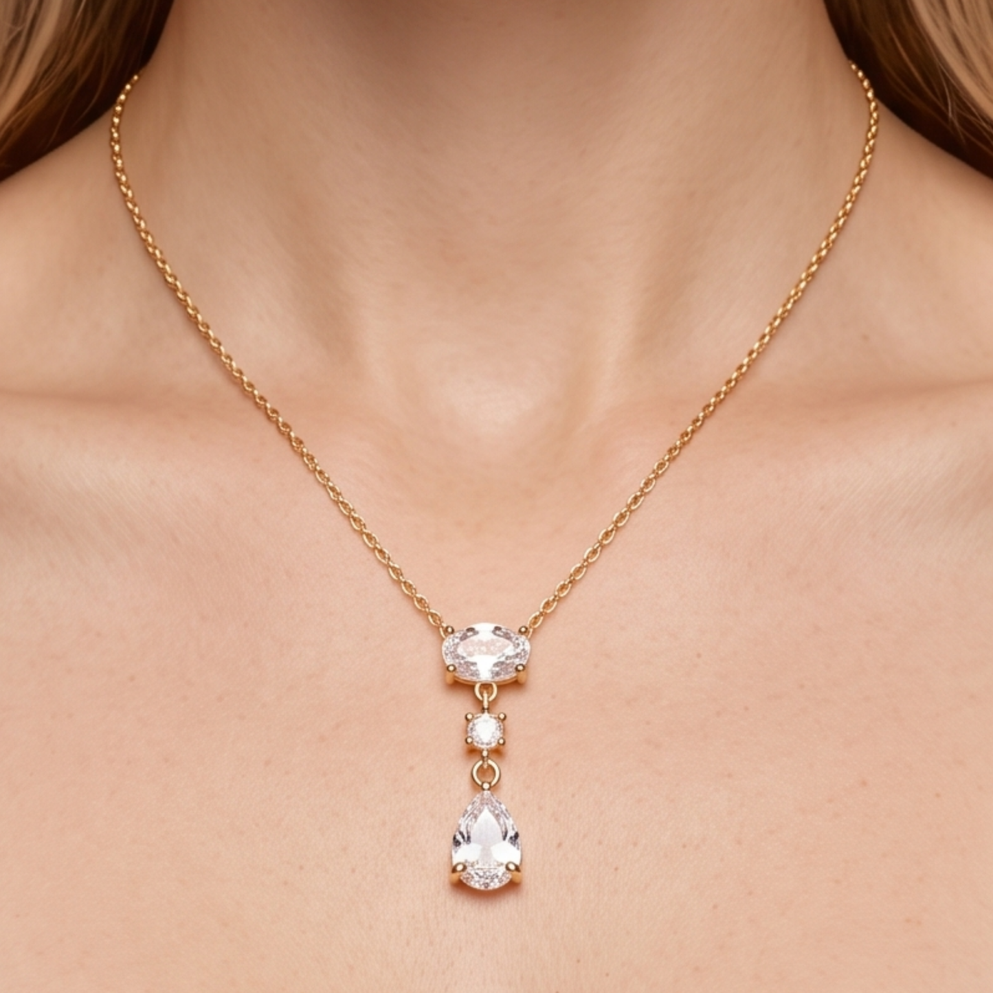 Crystal teardrop necklace styled on a woman, showcasing the elegant gold-tone chain and sparkling pear-shaped pendant by ZARIVA.