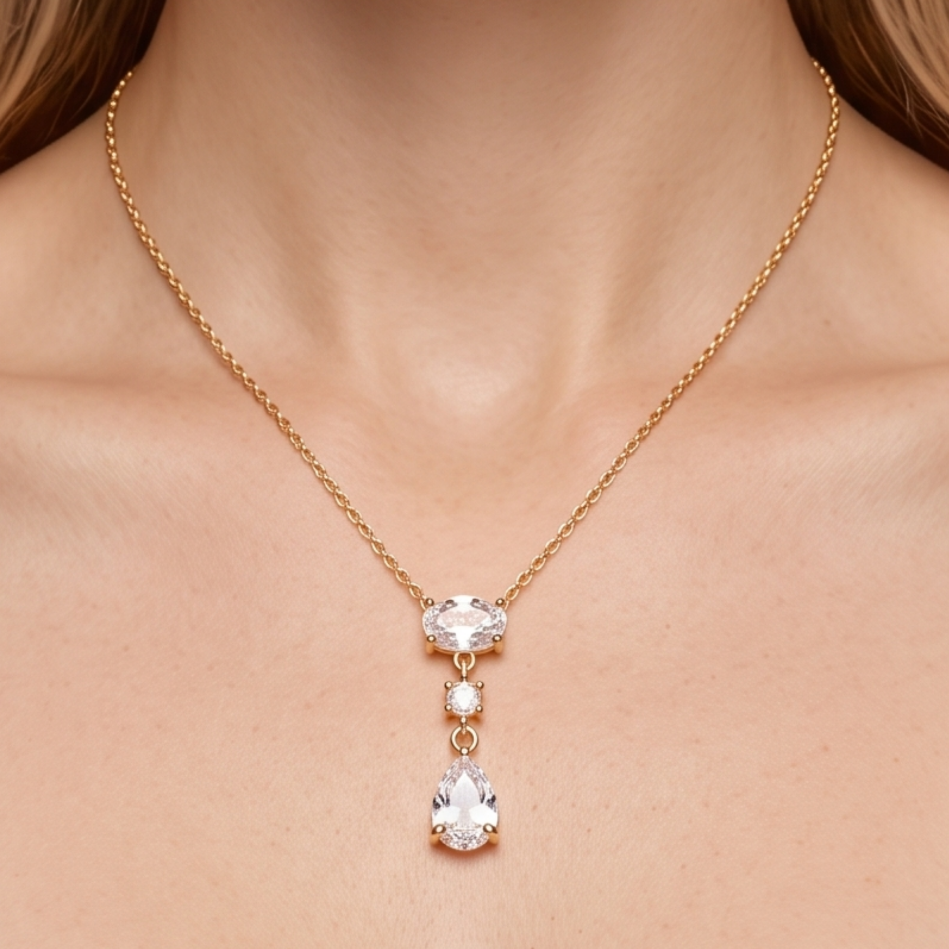 Crystal teardrop necklace styled on a woman, showcasing the elegant gold-tone chain and sparkling pear-shaped pendant by ZARIVA.