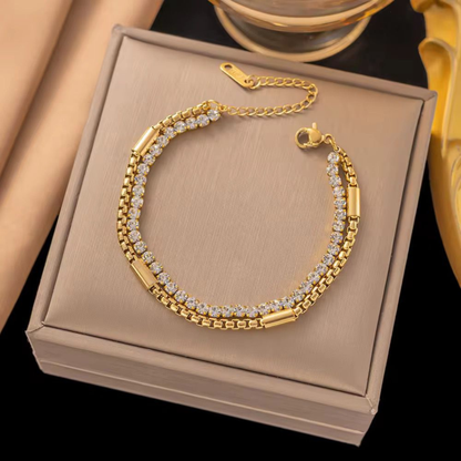 Double-row tennis bracelet in gold-tone finish displayed on a jewellery box, showcasing ZARIVA demi-fine jewellery.