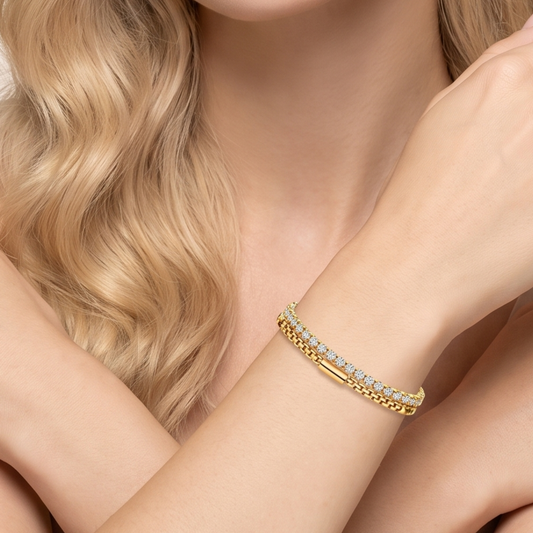 Double-row tennis bracelet worn on a woman's wrist, showing the gold-tone double-row design by ZARIVA.