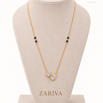 Duo crystal mangalsutra displayed on a ZARIVA jewellery bust, highlighting its gold-tone chain, black beads and crystal motif.
