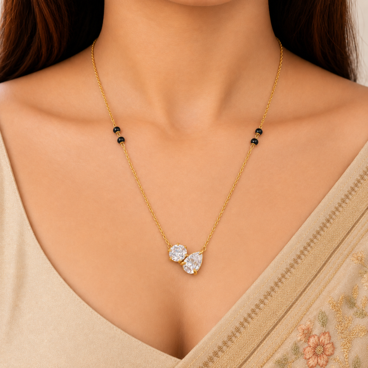 Duo crystal mangalsutra styled on a white outfit, showing its delicate gold-tone chain, black beads and sparkling dual-stone pendant.