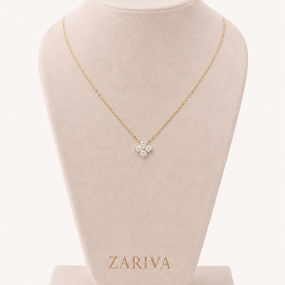 Four-Petal Crystal Flower Necklace by ZARIVA styled on a woman, featuring a delicate gold-tone chain and sparkling floral pendant.