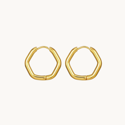 Gold hexagon hoop earrings with a smooth rounded geometric silhouette and polished finish for contemporary styling by ZARIVA.