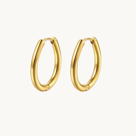 Gold oval hoop earrings with a smooth elongated silhouette and polished tubular finish for refined everyday styling by ZARIVA.