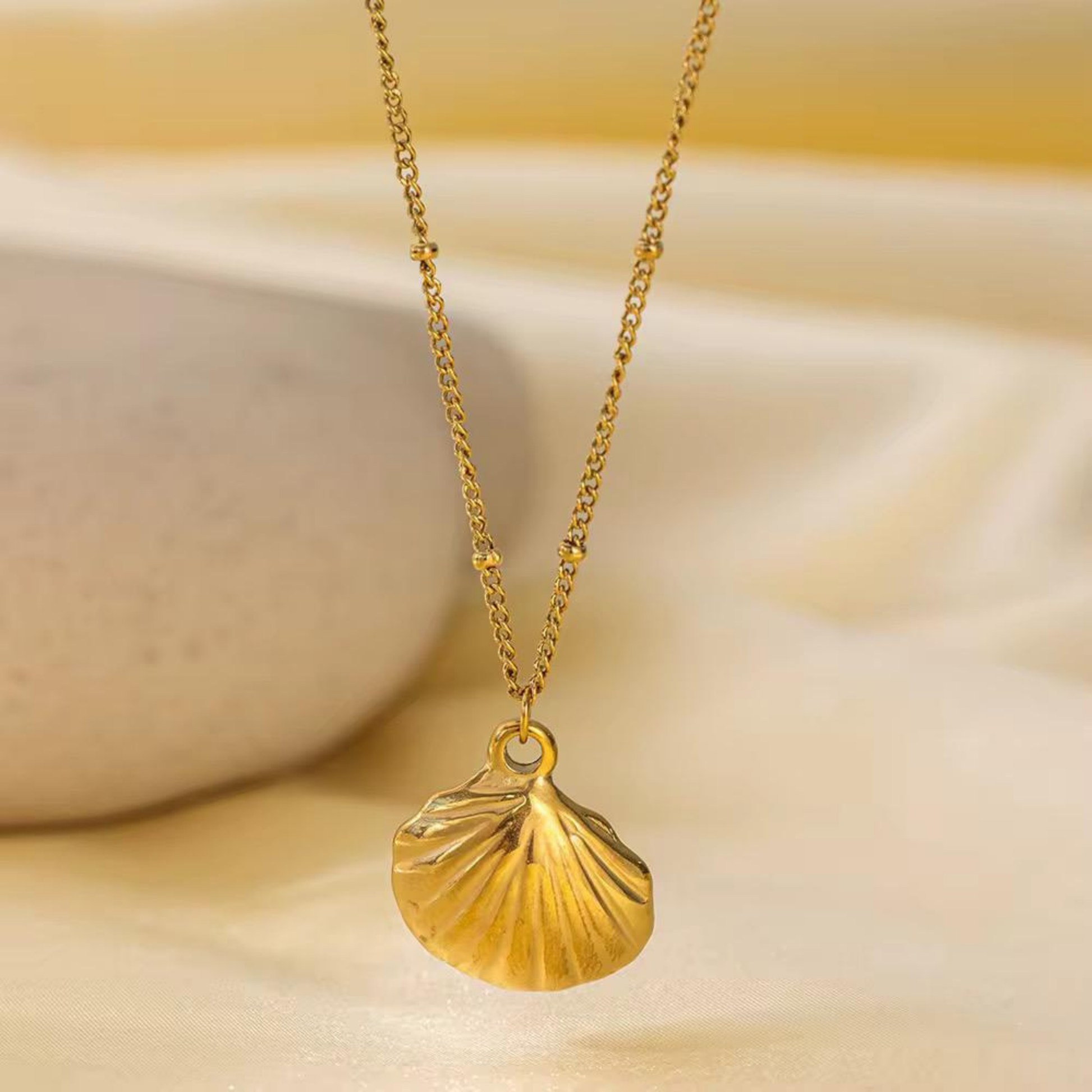 Gold seashell pendant jewellery featuring detailed shell ridges and a delicate gold chain for an elegant everyday look