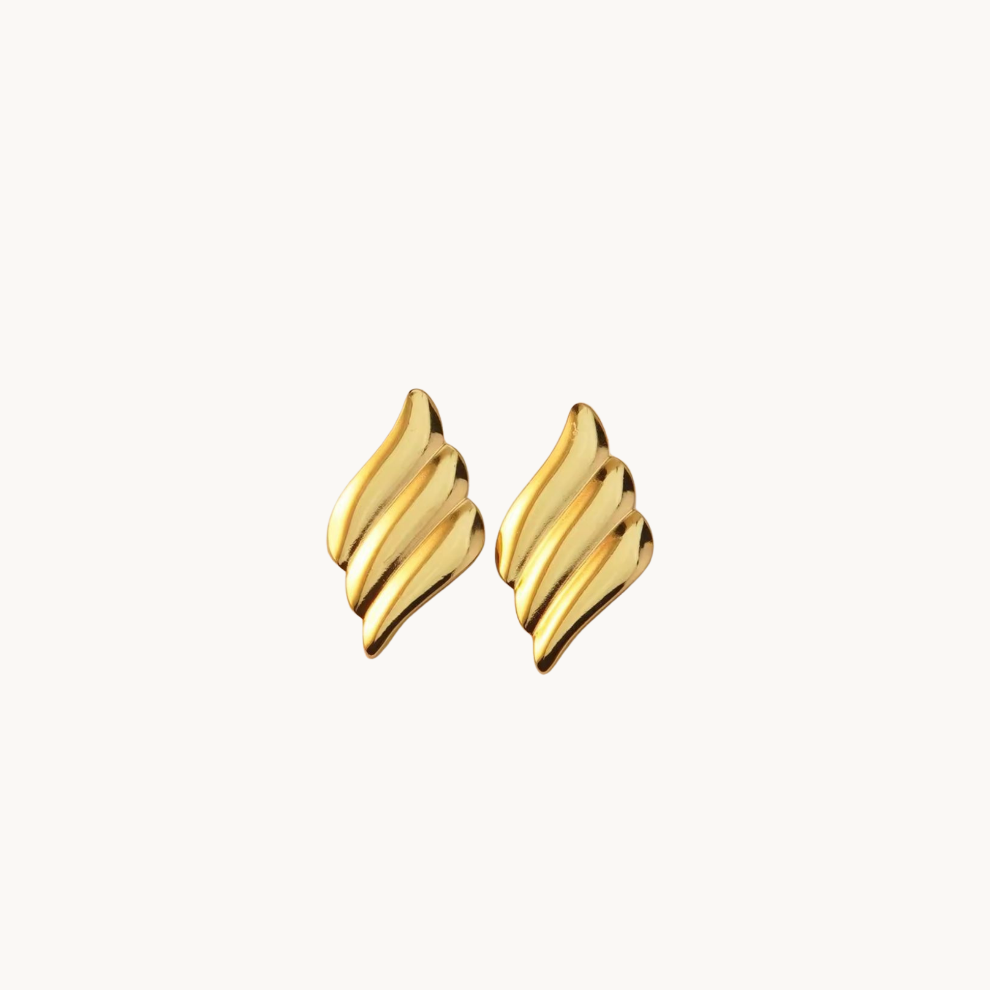 Gold statement earrings with a sculptural layered design, showcasing polished golden curves for an elegant contemporary look by ZARIVA.