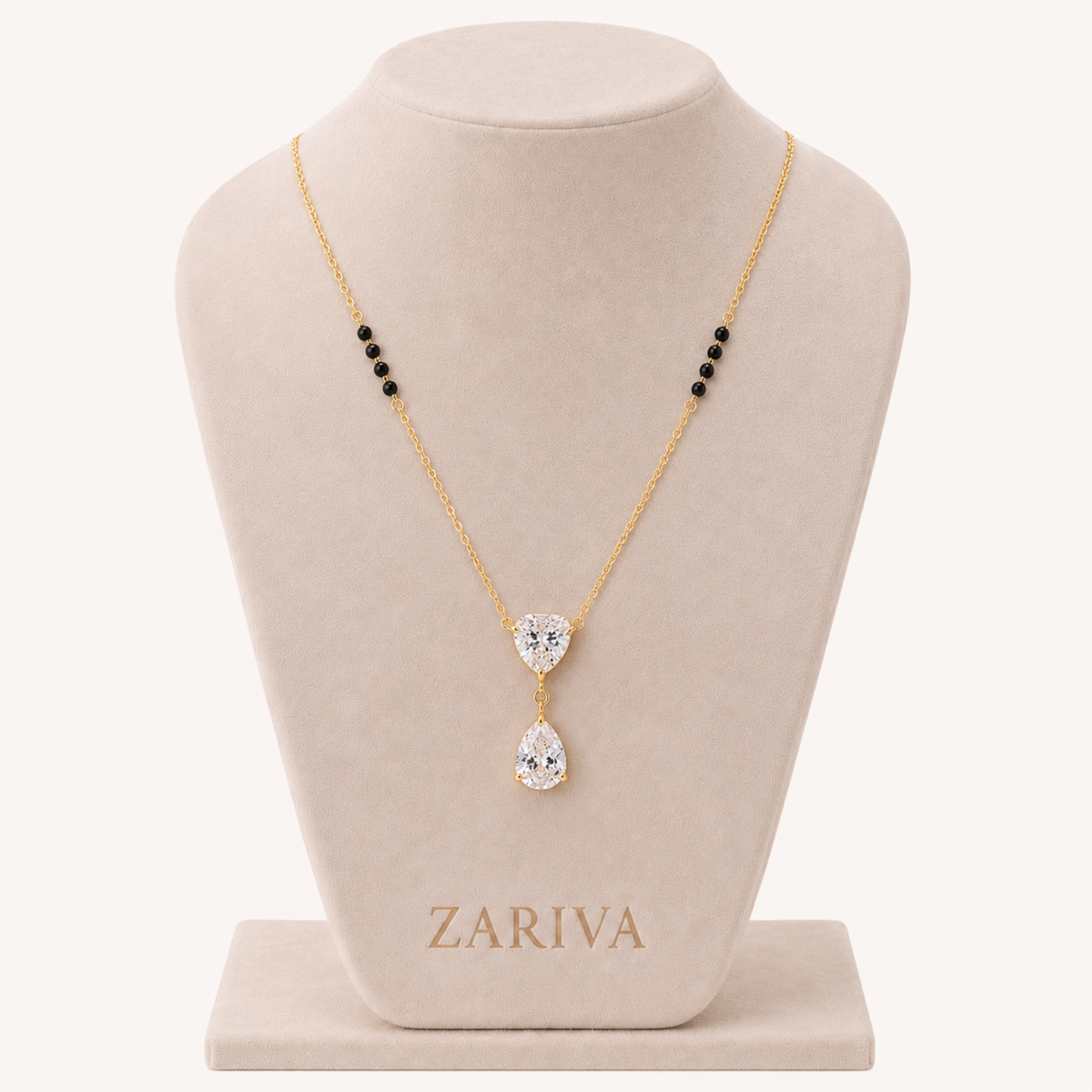 ZARIVA mangalsutra with a sparkling heart-shaped pendant and teardrop cubic zirconia stone on a delicate gold-tone chain.