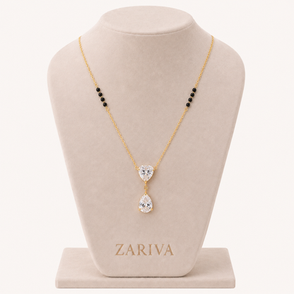 ZARIVA mangalsutra with a sparkling heart-shaped pendant and teardrop cubic zirconia stone on a delicate gold-tone chain.