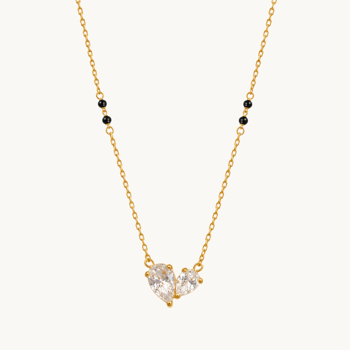 ZARIVA mangalsutra featuring a sparkling open heart pendant with faceted cubic zirconia stones and black beads.
