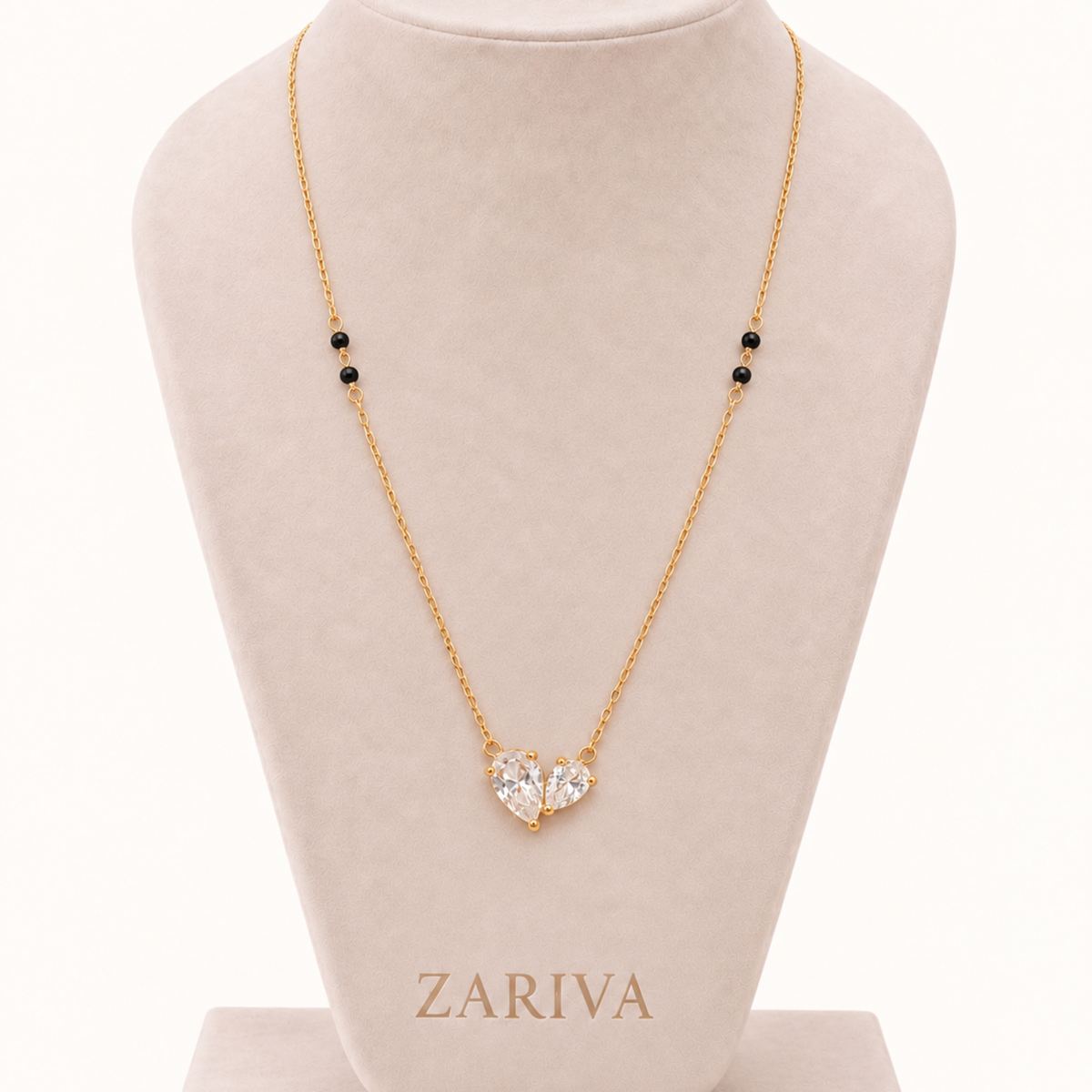 ZARIVA mangalsutra displayed on a jewellery bust with an open heart crystal pendant and delicate gold-tone chain.