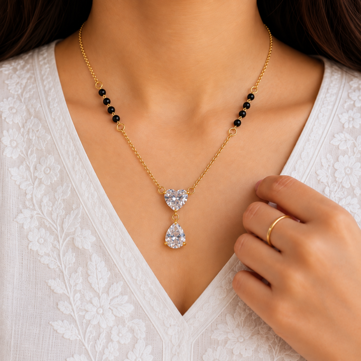 ZARIVA mangalsutra featuring a heart pendant and teardrop stone, styled as elegant everyday jewellery for women.