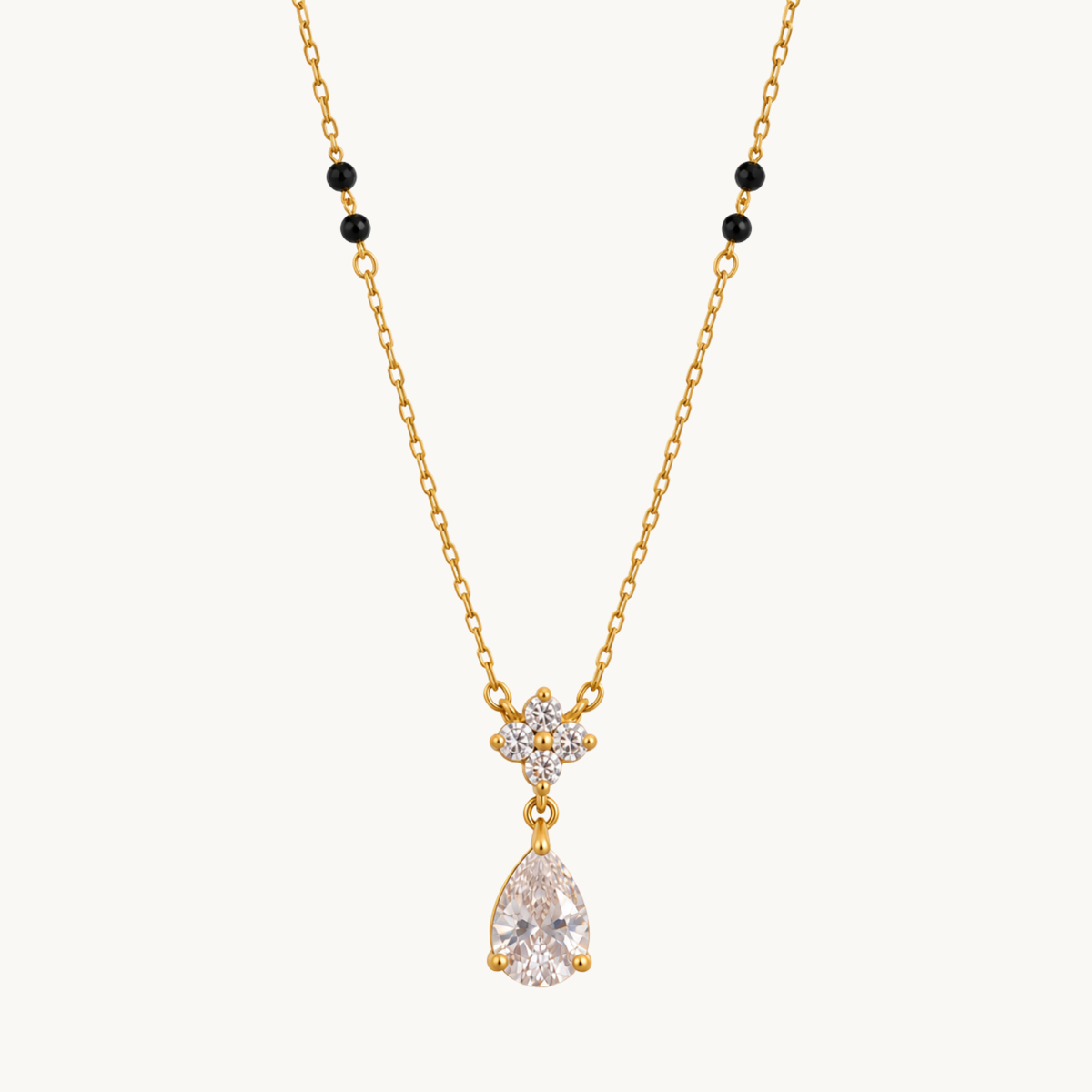 ZARIVA mangalsutra with black beads, a floral crystal cluster and sparkling teardrop pendant on a gold-tone chain.