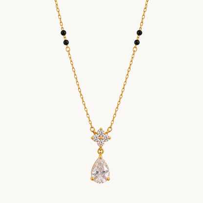ZARIVA mangalsutra with black beads, a floral crystal cluster and sparkling teardrop pendant on a gold-tone chain.