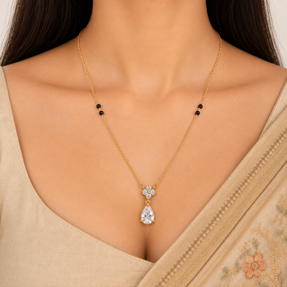 ZARIVA mangalsutra with a floral crystal cluster and teardrop pendant styled with an elegant Indian saree.