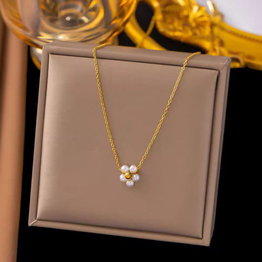 Pearl Blossom Pendant Necklace featuring a floral cluster of white pearls and a polished gold-tone centre on a fine chain