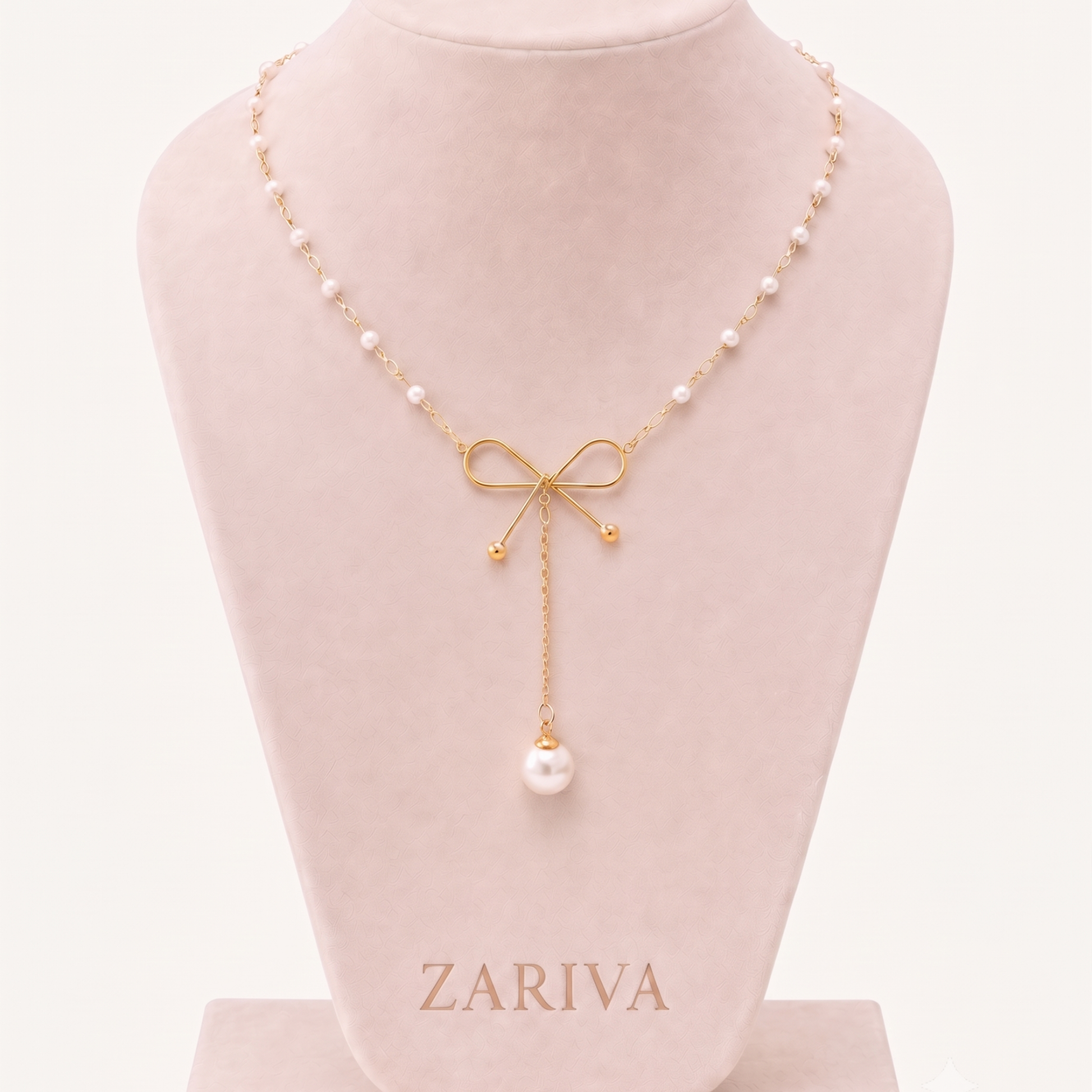 Pearl Bow Necklace displayed on a jewellery bust, highlighting its gold bow design, pearl chain and statement pearl pendant