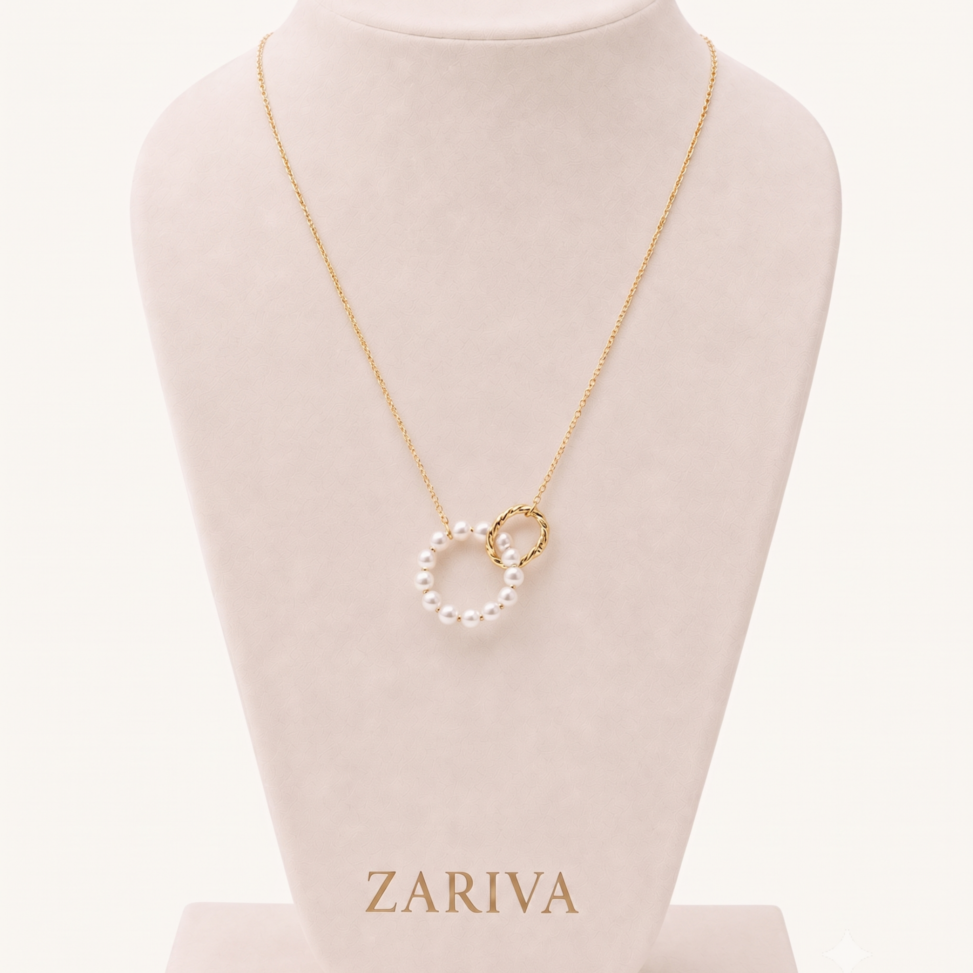 Pearl circle necklace with a white pearl pendant and textured gold-tone circular charm displayed on a delicate fine-link chain.
