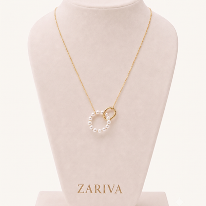 Pearl circle necklace with a white pearl pendant and textured gold-tone circular charm displayed on a delicate fine-link chain.