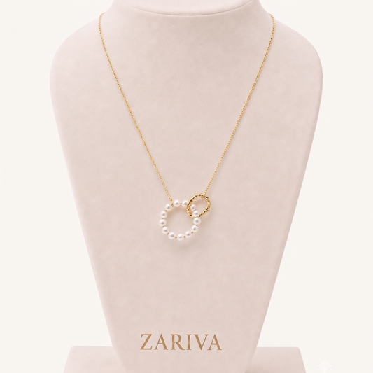 Pearl Circle Pendant Necklace by ZARIVA worn on a woman, featuring a delicate pearl circle and gold-tone ring pendant.