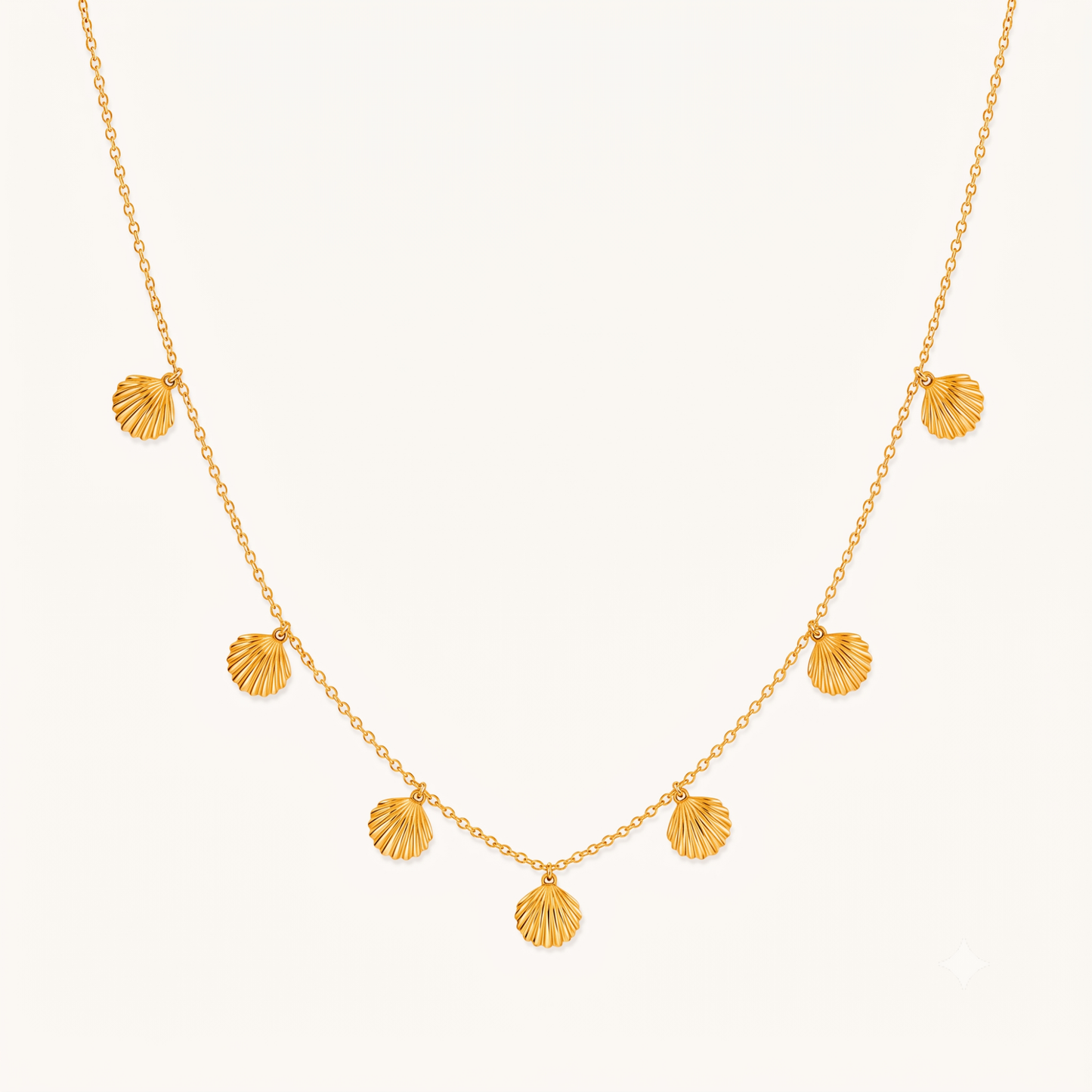 Seashell necklace with multiple gold shell charms on a delicate chain, showcasing ZARIVA's elegant coastal-inspired jewellery design.