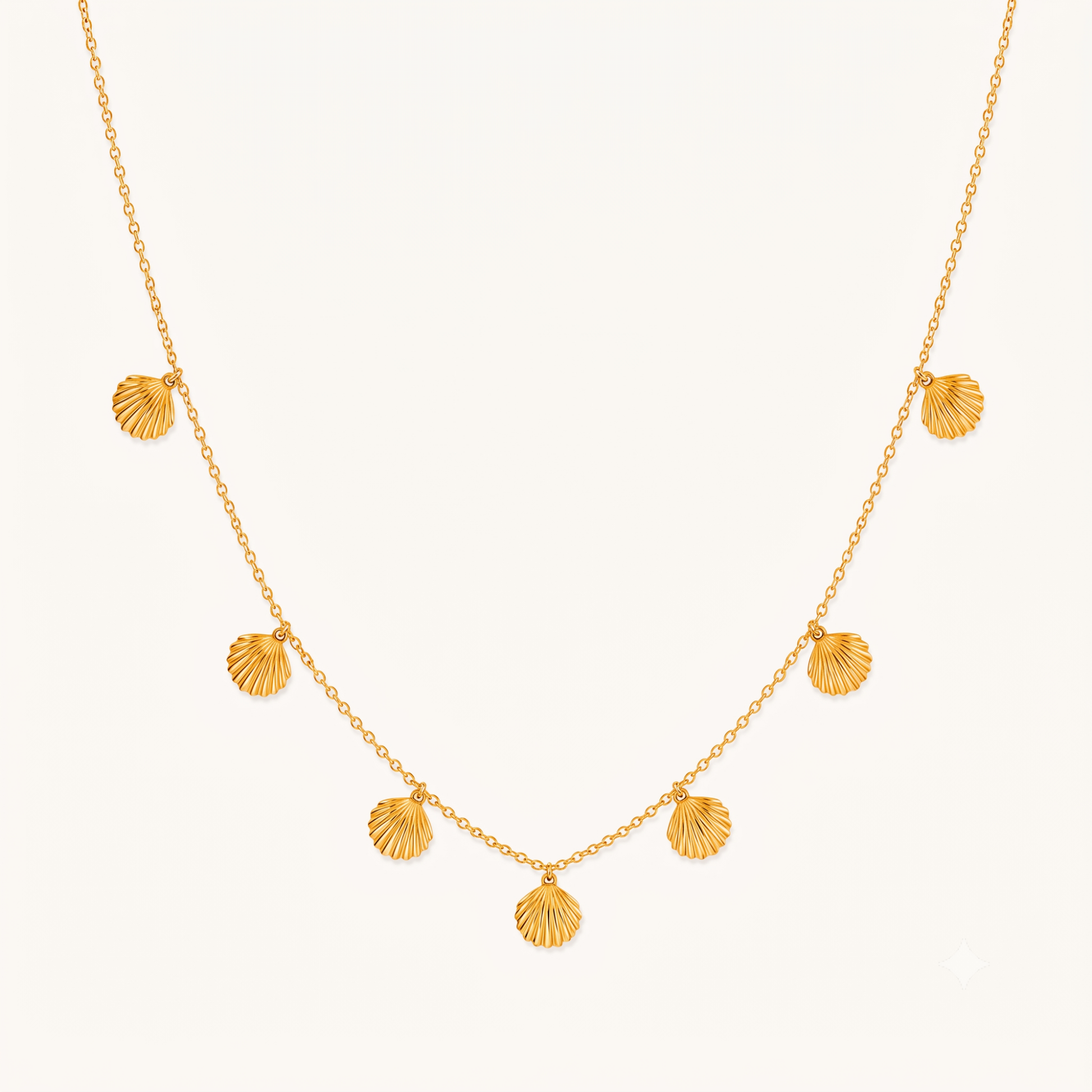 Seashell necklace with multiple gold shell charms on a delicate chain, showcasing ZARIVA's elegant coastal-inspired jewellery design.