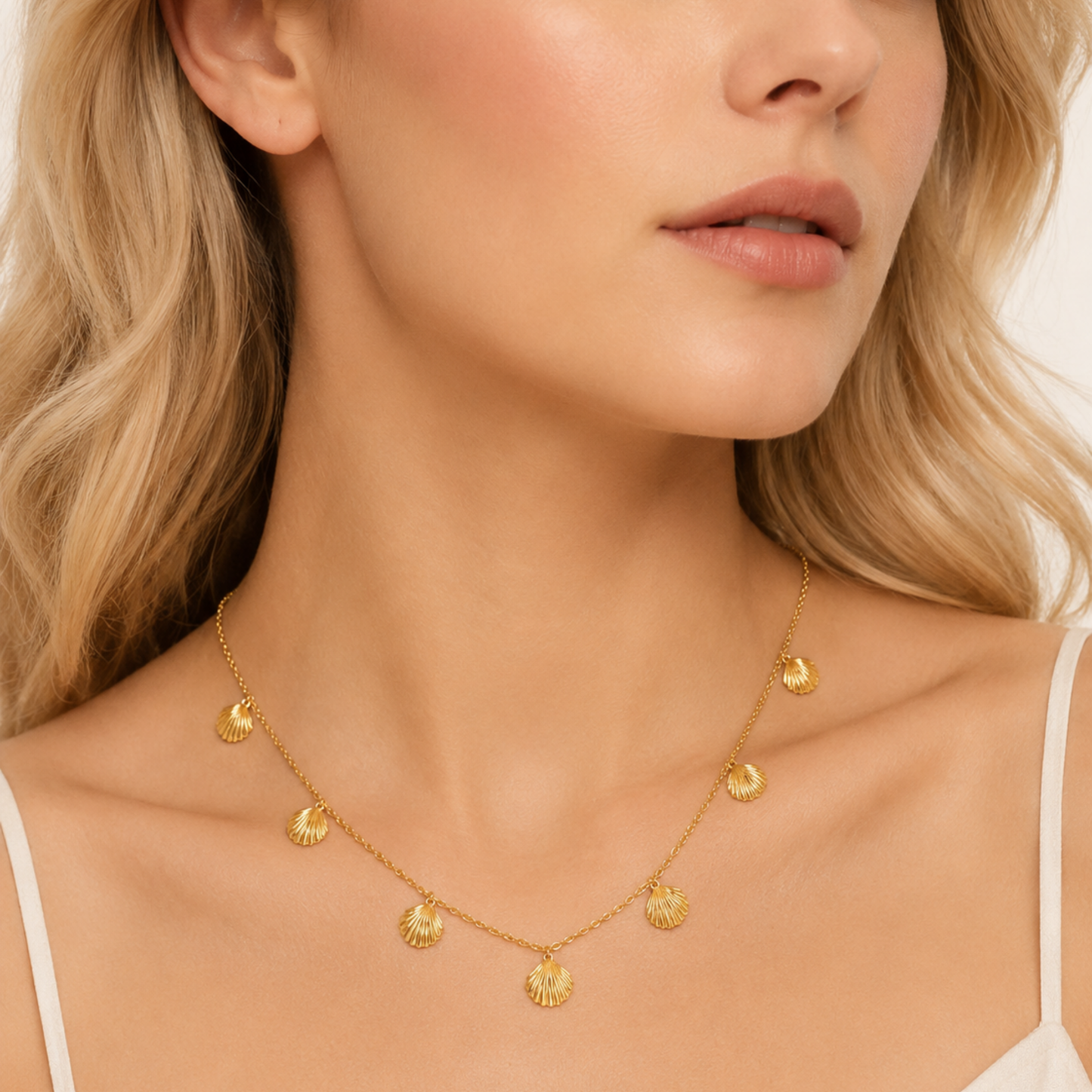 Seashell necklace worn by a woman, featuring multiple textured gold shell charms for an elegant everyday jewellery look by ZARIVA.