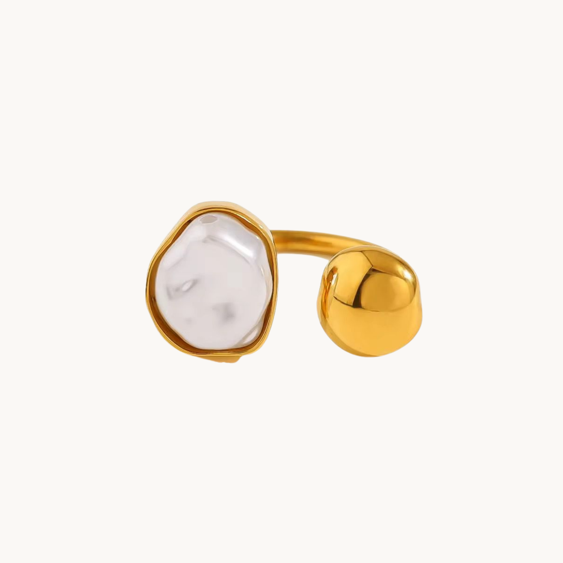White stone open ring with a gold finish worn on a woman's hand, showcasing its sculptural design and elegant everyday style.