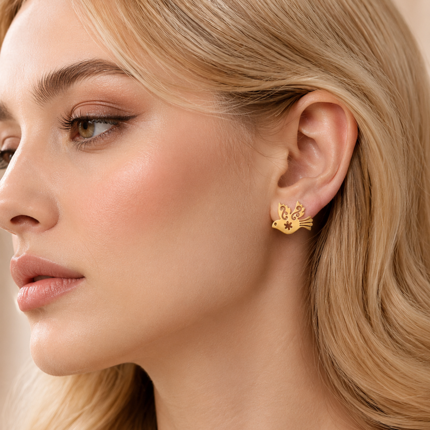 ZARIVA Paloma Élan Peace Dove Mini Stud Earrings displayed on a satin background. Premium SS316L stainless steel earrings with 18K PVD gold plating, anti-tarnish finish and elegant dove design.